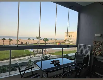a room with a table and chairs and a large window at Dokkali