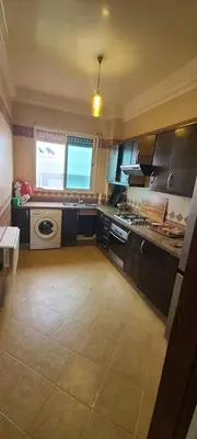 a kitchen with a sink and a stove top oven at 2 bedrooms apt Ricoflores Mimosa in Mohammedia