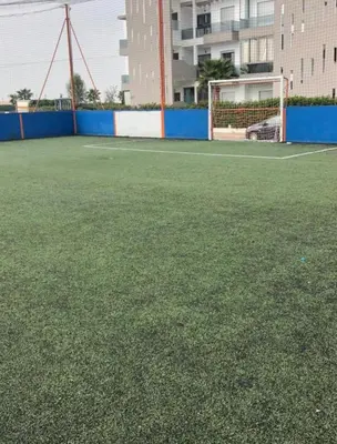 a soccer field with a goal and a soccer ball at Appt moderne 3 chbr Blanca Beach in Sidi Rahal