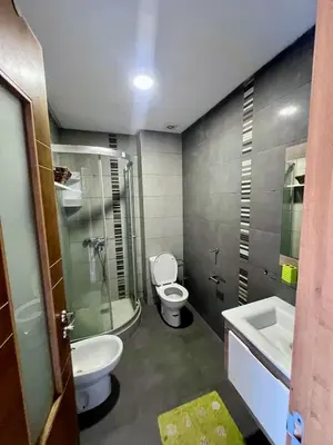 a bathroom with a toilet and a shower and a sink at Appt moderne 3 chbr Blanca Beach in Sidi Rahal