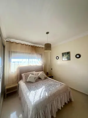 a bedroom with a large bed with a window at Appt moderne 3 chbr Blanca Beach in Sidi Rahal