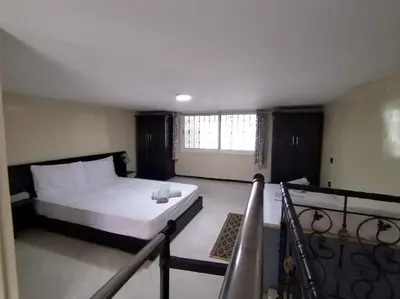a bedroom with a white bed and a balcony at Studio with Swimmingpool in Harhoura in Temara