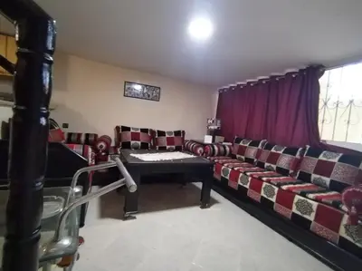 a living room with a couch and a table at Studio with Swimmingpool in Harhoura in Temara