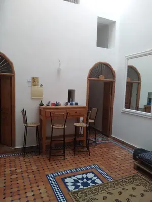 a living room with a table and chairs and a table and a table at Studio with Swimmingpool in Harhoura in Temara