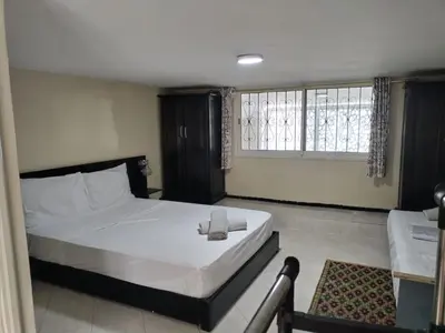 a bedroom with a large white bed and a window at Studio with Swimmingpool in Harhoura in Temara