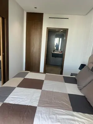 a bedroom with a bed with a checkerboard pattern on it at Charming Studio in Oasis in Oulad Akkou