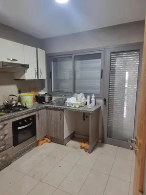 a kitchen with a counter top and a kitchen at Appartement Confortable à Tamaris Piscine, Jacuzzi, Proche de la Mer in Tamaris