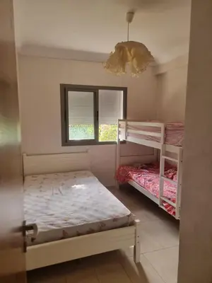 a bedroom with two bunk beds and a window at Appartement Confortable à Tamaris Piscine, Jacuzzi, Proche de la Mer in Tamaris