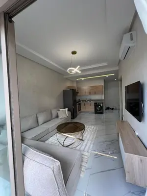 a living room with a couch and a table at Zenata tower in Casablanca