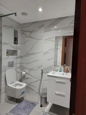 a bathroom with a toilet and a sink at اجمل شقة in Temara