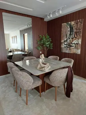 a dining room with a table with a statue on it at اجمل شقة in Temara