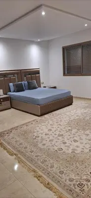 a bedroom with a bed and a rug at Exclusive Luxury Suite in Rabat City Center in Rabat