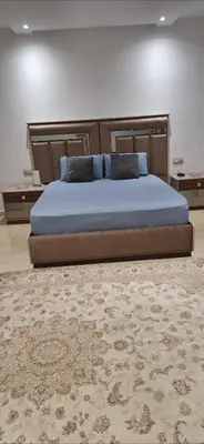 a large bed in a bedroom with a rug at Exclusive Luxury Suite in Rabat City Center in Rabat
