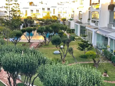 a view of a park with trees and buildings at Luxury Sea View in Tamaris