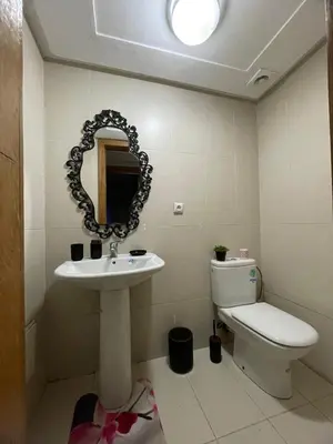 a bathroom with a sink and a toilet and a mirror at Luxury Sea View in Tamaris
