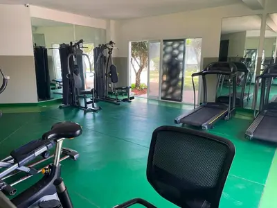 a gym with several treadmills and exercise machines at Luxury Sea View in Tamaris