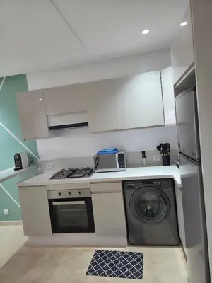 a kitchen with a stove and a washing machine at Le CasaStud' in Casablanca