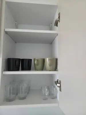 a shelf with bowls and other glass items on it at Le CasaStud' in Casablanca