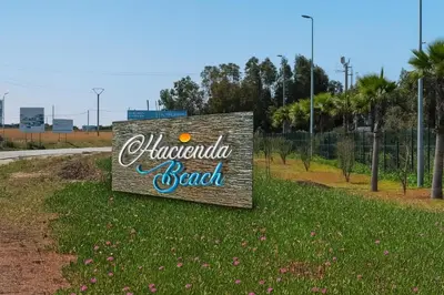 a sign that says albuquerque beach on the side of a road at Magnifique appartement 2 chambres vue sur piscine - Sidi Rahal in Sidi Rahal