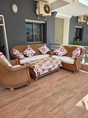 a living room with two couches and a coffee table at Mansouria in Mohammedia