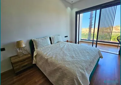 a bedroom with a bed and a large window at Le Refuge Océanique idéal ! in O Ben Slimane