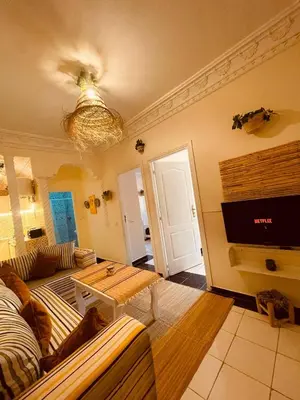 a living room with a couch and a table at Pleasant Studio in Casablanca in Casablanca