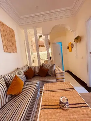a living room with a large couch in a room at Pleasant Studio in Casablanca in Casablanca