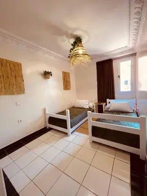 a living room with two beds and a chandelier at Pleasant Studio in Casablanca in Casablanca