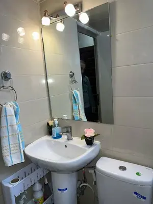 a bathroom with a sink and a toilet and a mirror at Appartement Authentique & Moderne au Cœur de la Médina in Casablanca