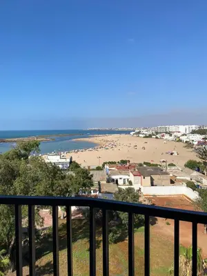 a view of a beach from a balcony at M'ocean Sea View Apartment by 7AV Hotels in Mohammedia