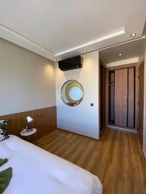 a bedroom with a bed and a mirror on the wall at M'ocean Sea View Apartment by 7AV Hotels in Mohammedia