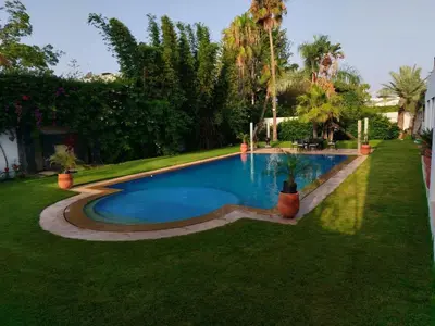 a swimming pool in the middle of a yard at Luxury Villa with pool 6 min to Football Stadium CAF in Rabat
