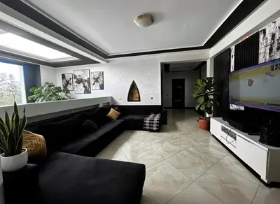 a living room with a couch and a flat screen tv at Luxury Villa with pool 6 min to Football Stadium CAF in Rabat