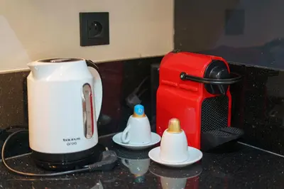 a kitchen counter with a coffee maker and a toaster at Central and Chic Apartment in the Heart of Casablanca Near To Station Tramway Abdelmoumen in Casablanca