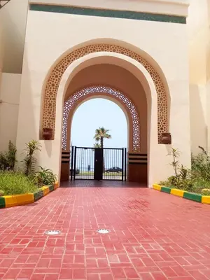 an entrance to a building with a brick floor and an archway at Chez Basma in Rabat
