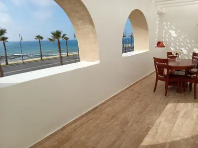 a dining room with a table and a view of the ocean at Chez Basma in Rabat