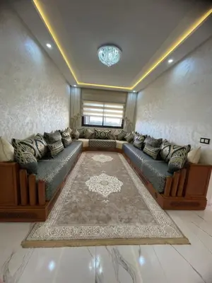 a large living room with couches and a rug at Apparemment propre pour location pour les familles in Casablanca