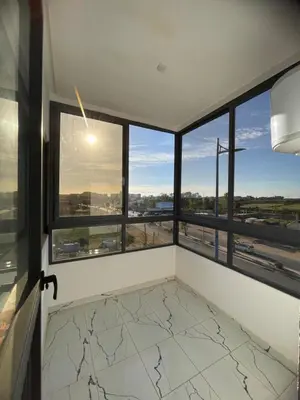 a room with windows and a view of the city at Apparemment propre pour location pour les familles in Casablanca