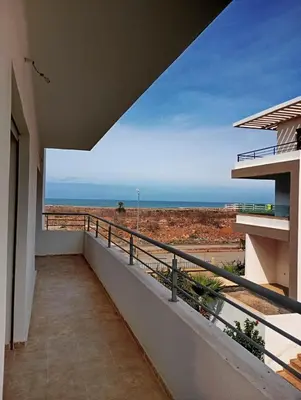 a balcony with a view of the ocean at Location de vacances 3 chambres in Mansouria
