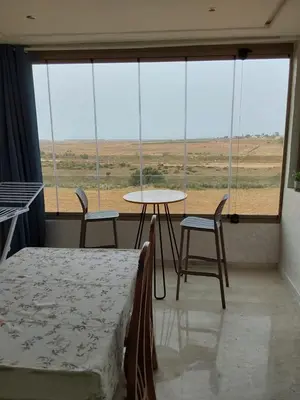 a room with a bed and a table and chairs at Evasion Prince 1 in Sidi el Haj Bou Derbala