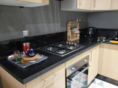 a kitchen with a stove and a plate of food at Evasion Prince 1 in Sidi el Haj Bou Derbala