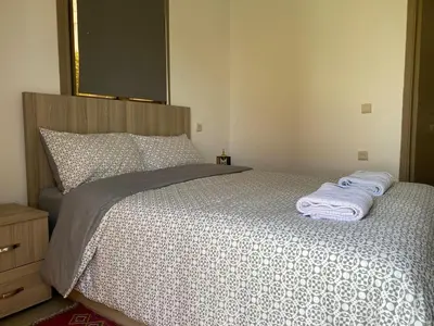 a bedroom with a bed with two towels on it at Farm - Private pool - Games - Nature in El Jadida
