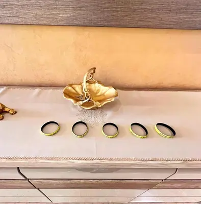 a group of gold shoes and a purse on a table at Elegant & Spacious Apartment in Prestigia in Rabat