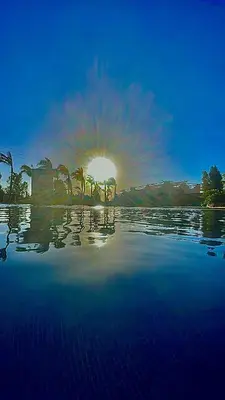 a view of the sun setting over a body of water at Farm with villa and pool in Settat
