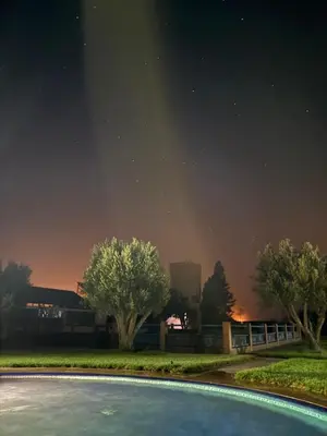 a night view of a swimming pool at night at Farm with villa and pool in Settat