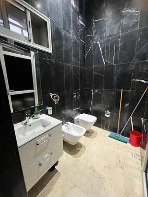 a bathroom with two sinks and a toilet in it at Farm with villa and pool in Settat