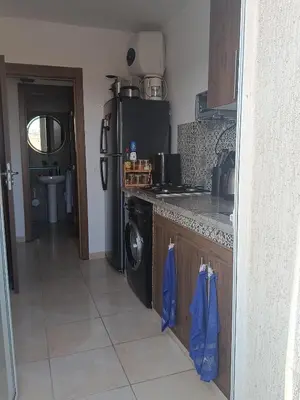 a kitchen with a stove and a dishwasher at Cosy Bernoussi in Casablanca