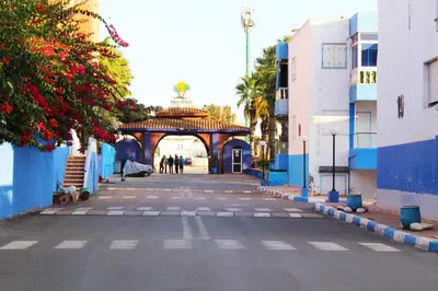an empty street with an archway in a city at Palm beach in Mansouria in O Ben Slimane