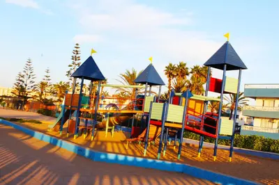 a playground with colorful equipment on a beach at Palm beach in Mansouria in O Ben Slimane