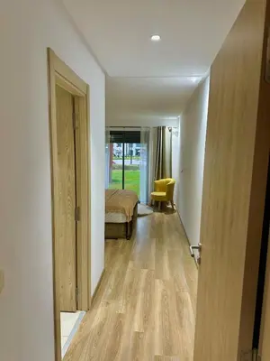 a hallway with a room with a bed and a door at Residence Bleu Dhalia in Sidi Rahal